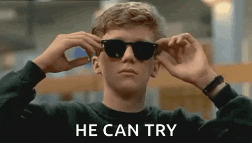 a young man is wearing sunglasses and the words `` he can try '' are written on the screen .