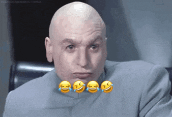 a bald man in a suit with smiley faces on his face is laughing .
