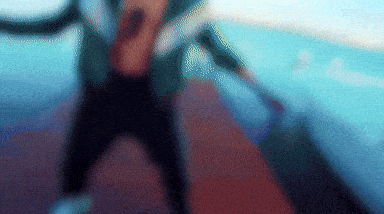a blurry picture of a person holding a sword in their hand .