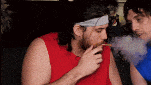 a man wearing a headband smoking a cigarette