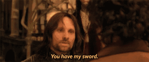 a man with long hair and a beard is talking to another man and says `` you have my sword . ''