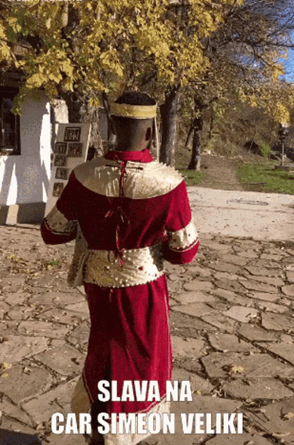 a man in a red and gold costume with the words " slava na car simeon veliki "