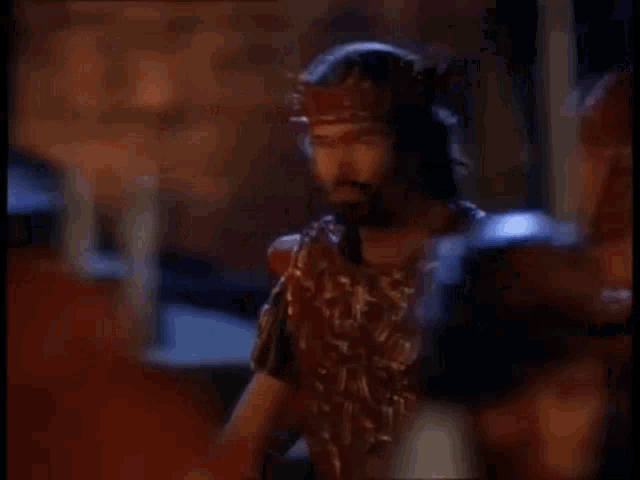 a group of people holding swords are standing in a dark room