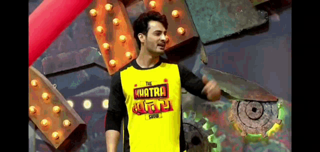 a man is wearing a yellow shirt that says the kuatra show