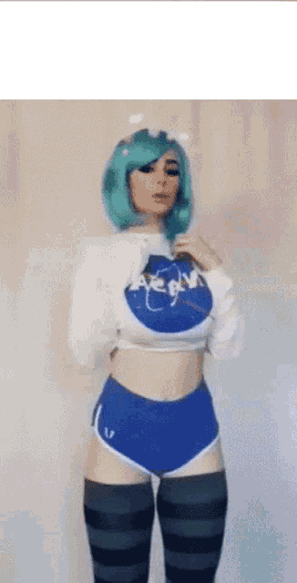 a woman with green hair and a nasa shirt on