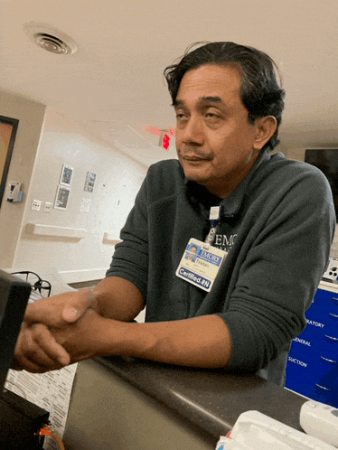 a man wearing a name tag that says certified sn