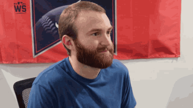 a man sitting in front of a ws sign