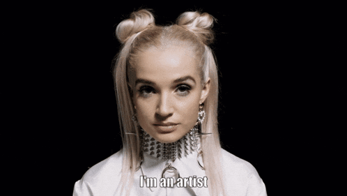 a woman says i 'm an artist while wearing a white shirt