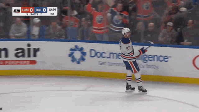a hockey player with the number 97 on his jersey is standing on the ice