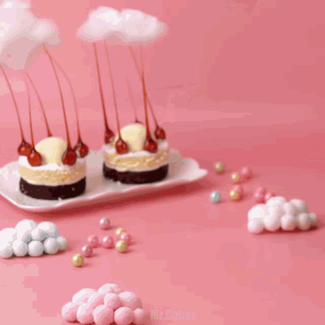 a few cakes with cotton candy sticks on top of them