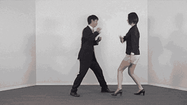 a man and a woman are dancing in a room