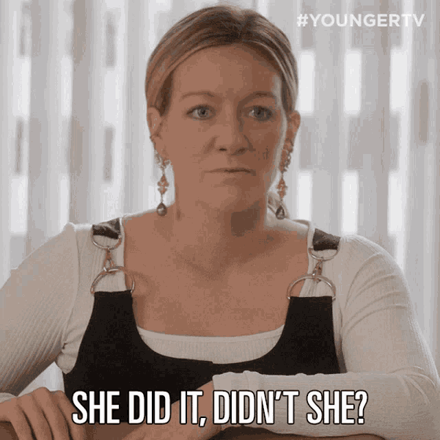 a woman is sitting at a table and says she did it did n't she