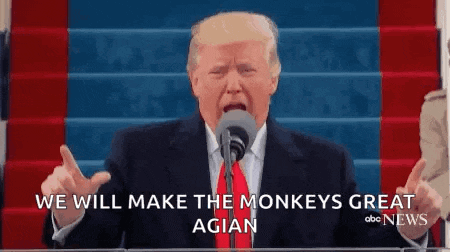 donald trump is speaking into a microphone and making a funny face .