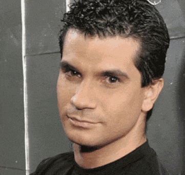 a man wearing a black shirt looks at the camera