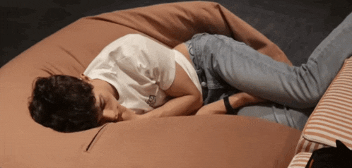 a person laying on a bean bag with a t-shirt that says ' i love you ' on the back