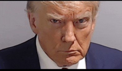 a close up of donald trump 's face in a suit and tie making an angry face .