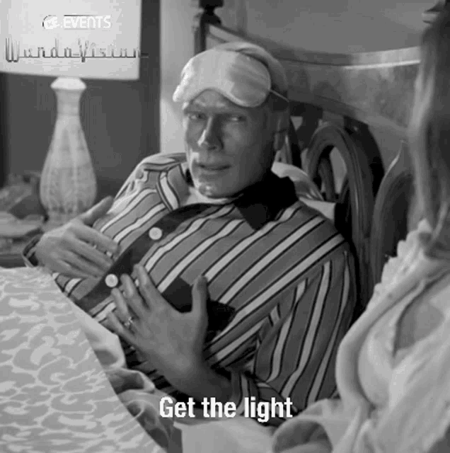 a black and white photo of a man wearing a sleep mask with the words get the light below him
