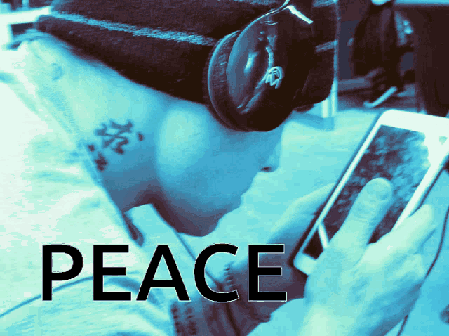 a person wearing headphones is looking at a cell phone with the word peace written on the bottom