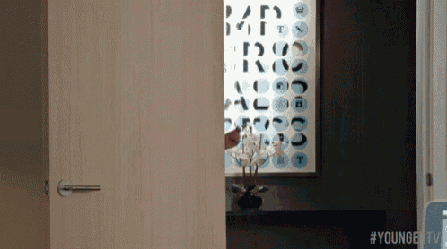 a doorway with a sign on the wall that says ' younger tv ' on it