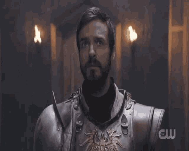 a man in armor says " with all my heart " in front of a cw logo