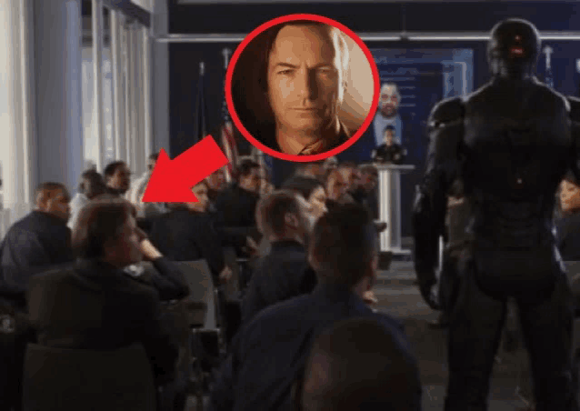 a man in a suit is standing in front of a crowd
