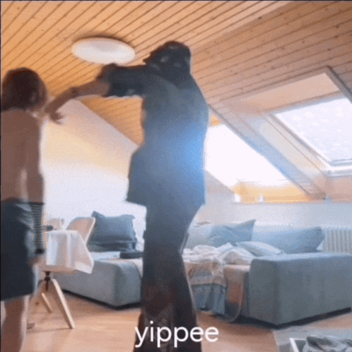 a person standing in a living room with the word yippee written on the floor