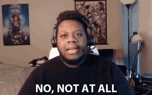 a man wearing headphones and a black shirt says no not at all