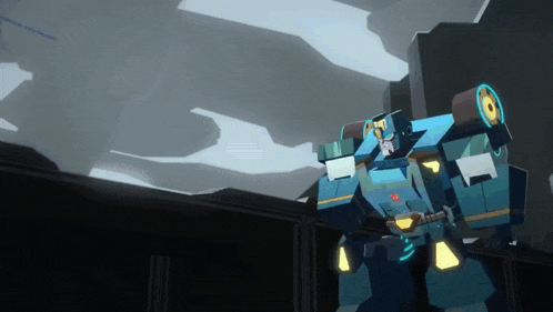 a transformer robot is standing in a dark room with a shadow on the wall .