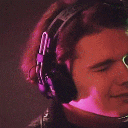a man is wearing headphones and making a face