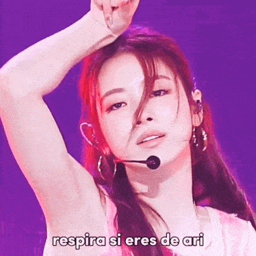 a woman wearing a microphone with the words " respira si eres de ari " on the bottom