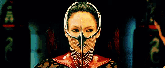 a woman wearing a mask with chains around her face