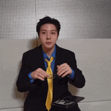 a man in a suit and tie is holding glasses