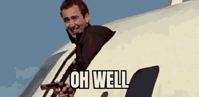 a man is holding a gun out of a plane window .