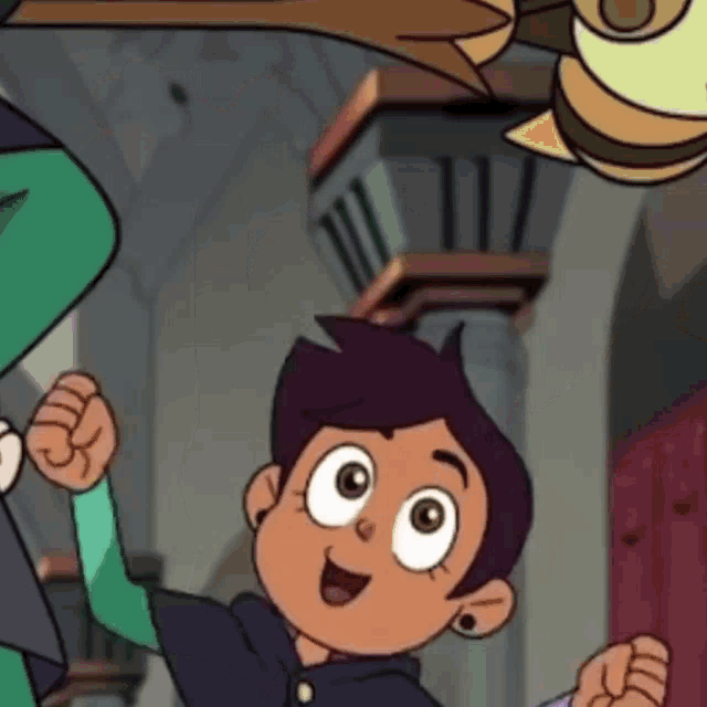 a close up of a cartoon character from the owl house holding a fist in the air .