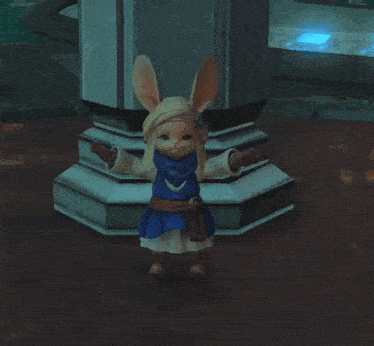 a stuffed bunny is standing next to a pillar in a dark room