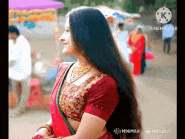 a woman with long hair is wearing a red saree