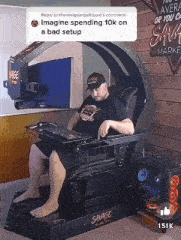 a man is sitting in a savage gaming chair with a keyboard