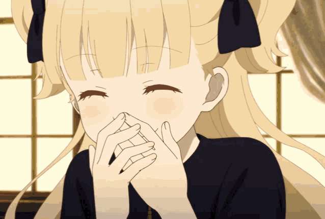 a girl with blonde hair is covering her mouth with her hand