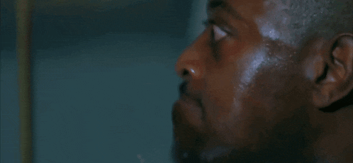 a close up of a man 's face with water coming out of it