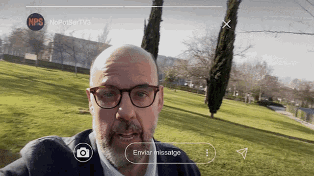 a man taking a selfie in a park with a nps logo on the top