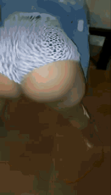 a blurry picture of a person 's butt with a leopard print shorts on
