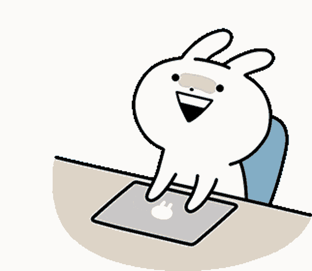 a cartoon rabbit is sitting at a desk with a laptop .