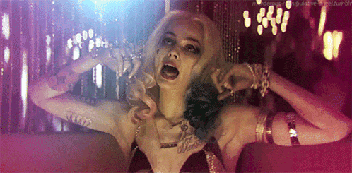 a woman in a suicide squad costume is screaming with her mouth open