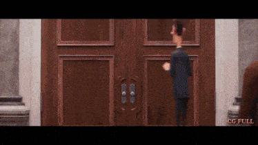 a man in a suit stands in front of a wooden door with the words cg full below him
