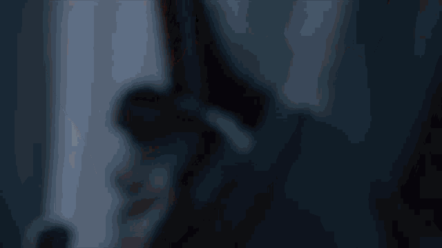 a close up of a person 's face with a blue sky in the background
