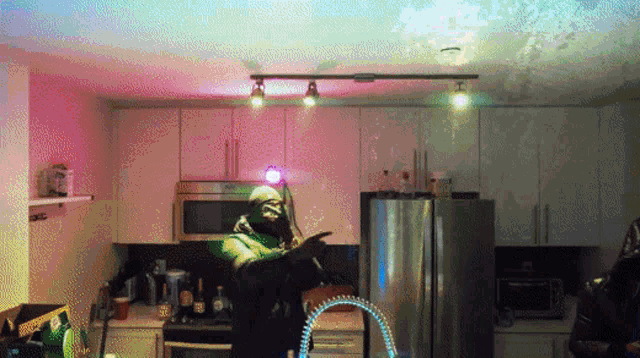 a man in a green jacket is standing in a kitchen holding a sword