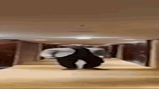 a person is standing in a hallway with their legs crossed .