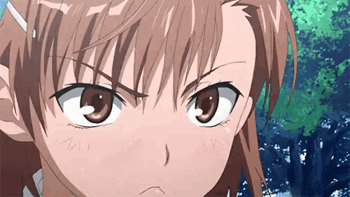a close up of a girl 's face with a serious look on her face