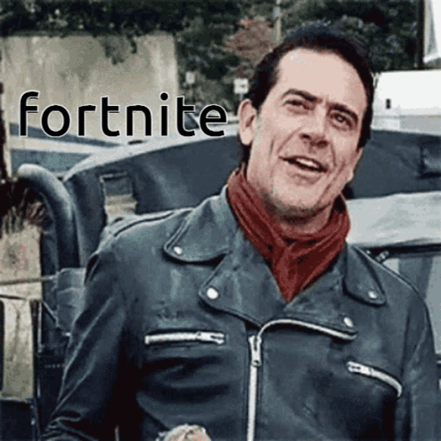 a man wearing a leather jacket and a scarf with the word fortnite behind him