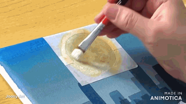 a person is using a brush on a piece of paper that says made in animatica on it